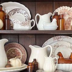 plates, dishes and vases are arranged on shelves