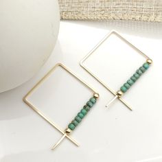 Show off your style with these stunning True earrings! Square 14k Gold Filled wire featuring turquoise Miyuki seed beads, they bring a playful touch of sophistication. Perfect for making a fashion statement! 14k Gold Filled square wire Earrings measure.75" on each side of the square Turquoise colored Miyuki Seed Beads Sent in a Ribboned Gift Box with Polishing Cloth Handmade in Montana Adjustable Square Turquoise Jewelry, Diy Statement Earrings, Miyuki Earrings, Wired Jewelry, Jewelry Booth, Work Earrings, Wire Ideas, Jewelry Display Cards, Earrings Square