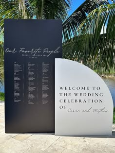 a welcome sign is shown next to a palm tree and the words on it are in cursive writing