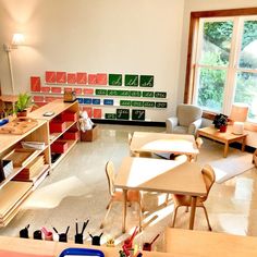 an empty classroom with desks, chairs and bookshelves on the floor in front of windows