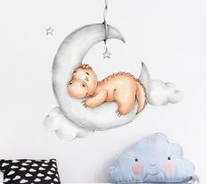 a baby is sleeping on the moon wall decal