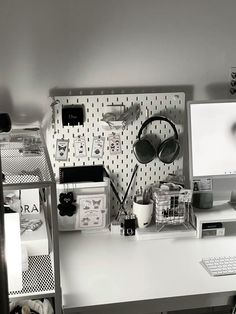 a white desk topped with a computer monitor and keyboard