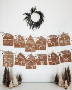 gingerbread houses and trees are hung on a string