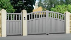 a grey gate with brick pillars and an arched top