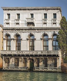 an old building sitting next to a body of water