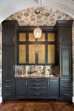 a kitchen with black cabinets and gold trimmings on the doors, counter tops and drawers