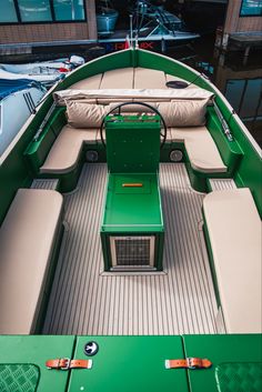 the inside of a green boat with white seats