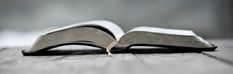 an open book sitting on top of a wooden table