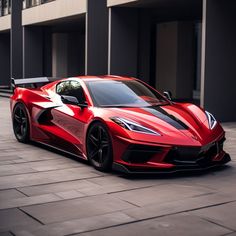 a red sports car parked in front of a building on a brick floored area