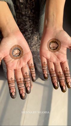 two hands with henna designs on them