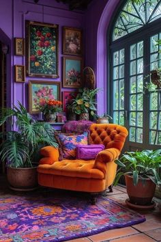 a living room with purple walls and lots of plants