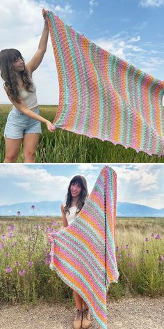 a woman holding up a colorful crocheted blanket in the middle of a field