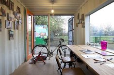 a bicycle is parked next to a wooden table