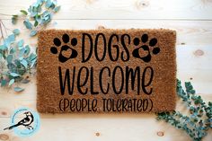 a welcome mat with the words dogs welcome people