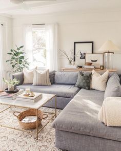 a living room filled with lots of furniture and decor on top of a white rug