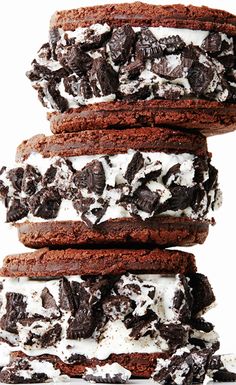 chocolate cookies and oreo cookies stacked on top of each other with white frosting