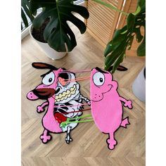 two pink rugs with cartoon characters on them