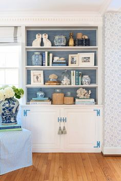 a blue and white china cabinet in a living room