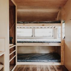 the bunk beds in this small room are made out of wood