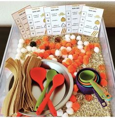 there are many different items in the container to be used for this activity, including spoons and utensils