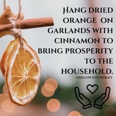 an orange hanging from a branch with the words hang dried oranges on garlands with cinnamon to bring prosperity to the household