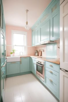 a kitchen with pastel blue cabinets and white flooring is pictured in this image