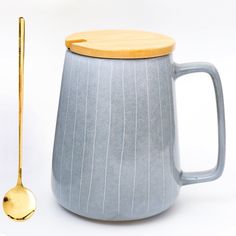 a ceramic mug with a wooden spoon next to it