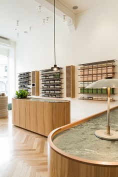 the inside of a nail salon with wooden counter tops and shelves filled with bottles on each shelf