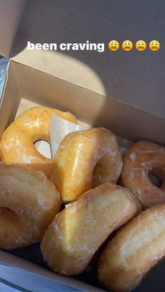 a box filled with lots of glazed donuts