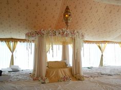 the canopy bed is decorated with flowers and curtains