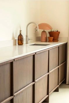 a kitchen with white counter tops and wooden cabinets