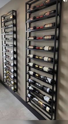 a wine rack with many bottles on it next to a wall filled with other wines