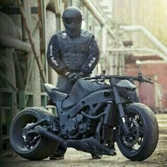 a man standing next to a parked motorcycle