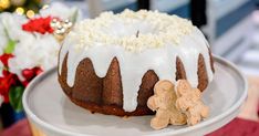 a bundt cake with white icing and sprinkles on a plate