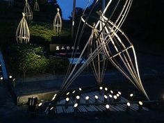 an artistic sculpture is lit up at night