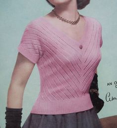 an old fashion magazine cover with a woman wearing a pink sweater and black gloves on her head