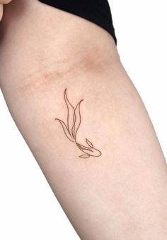 a woman's arm with a small tattoo on the left side of her body