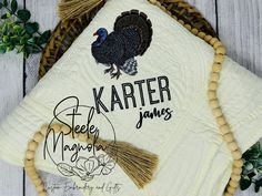 a white quilt with a turkey on it and the words karterr spelled in black