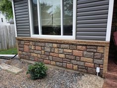 a brick wall in front of a house