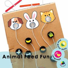 an animal feed fun box with buttons and pins attached to the front, on top of a piece of cardboard