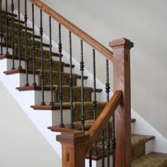 the stairs are made of wood and wrought iron