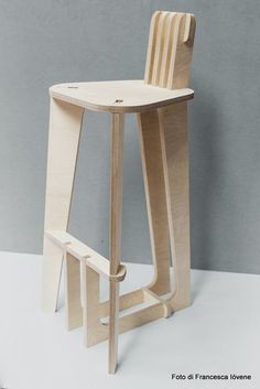 a wooden stool sitting on top of a white floor