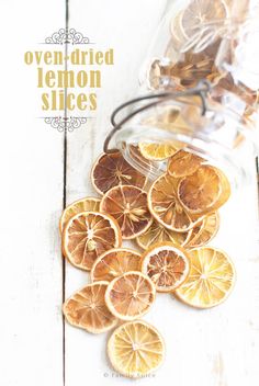 there are orange slices on the table next to a jar with lemon slices in it