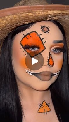 a woman with orange makeup and face paint on her face is wearing a straw hat