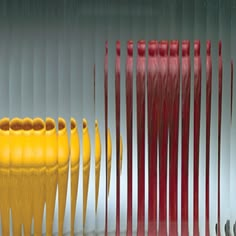 several yellow and red vases sitting next to each other