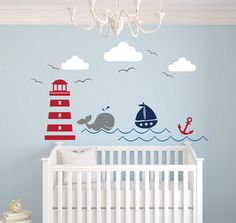 a baby's room with a crib and wall decals