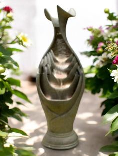 a vase sitting in the middle of some flowers