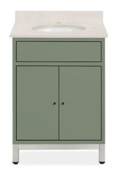 a white sink sitting next to a green cabinet with two doors on the front and bottom