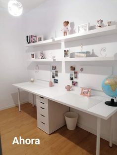 a white desk topped with lots of shelves filled with pictures and toys on top of it