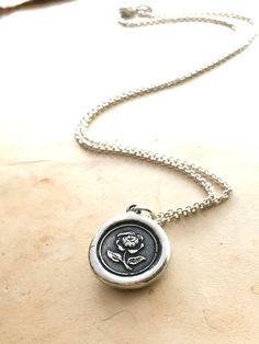 "This English Rose wax seal pendant is handmade made using a vintage Wax Seal from the early 1900's (Art Deco era). The rose symbolizes beauty, love, purity and passion and is also the symbol of motherhood. This necklace makes a meaningful heartfelt gift, it will arrive beautifully packaged and ready for gifting. D E T A I L S: * 925 Sterling Silver * Wax Seal Pendant is 3/4\" wide * Select from several 925 sterling silver chain styles or choose just the charm at checkout * Handmade in the USA N Vintage Rose Design Necklaces For Valentine's Day, Vintage Rose Design Jewelry As A Gift, Vintage Rose-colored Jewelry For Gifts, Classic Rose Design Jewelry For Gifts, Vintage Rose Necklace For Gift, Vintage Rose Color Necklace For Gift, Rose Vintage Necklace For Gift, Vintage Jewelry With Rose Design Flower Pendant, Vintage Rose Design Flower Pendant Jewelry